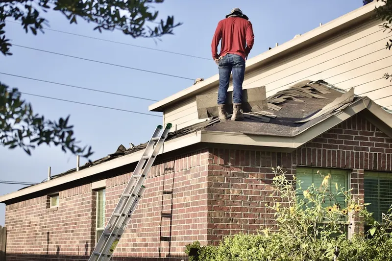 Professional roofer working on a residential roof in Wells Avenue Neighborhood